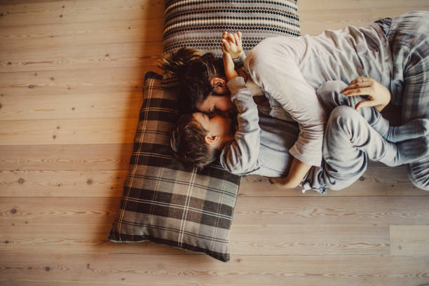 Loving mom tickling her kid on flooring | J/K Carpet Center, Inc