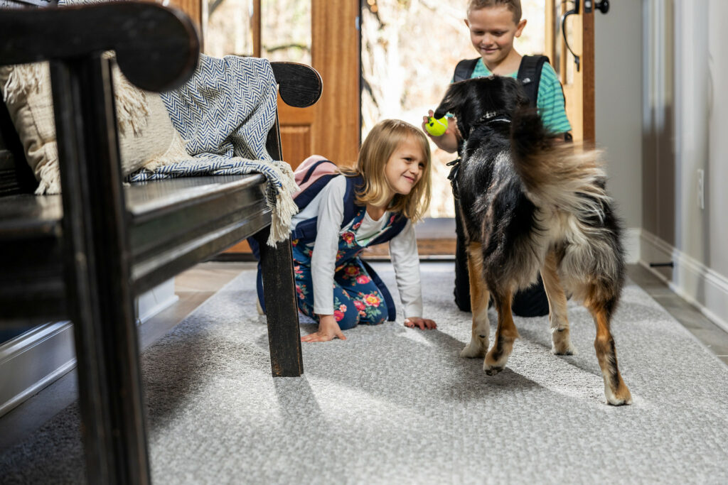 Kids playing with dog on carpet floors | J/K Carpet Center, Inc